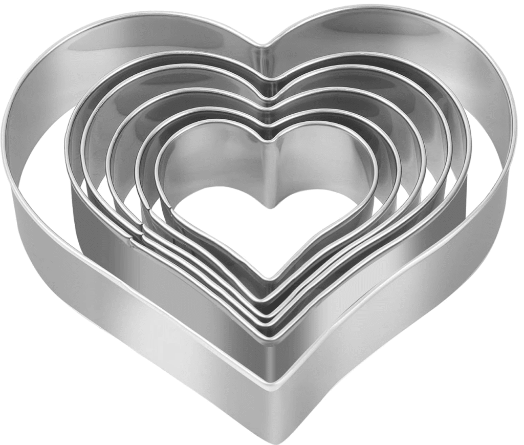 A set of five metal heart-shaped cookie cutters, perfect for crafting Valentine's Day delights or shaping Rice Krispie Treats, each varying in size and nested inside each other against a white background.